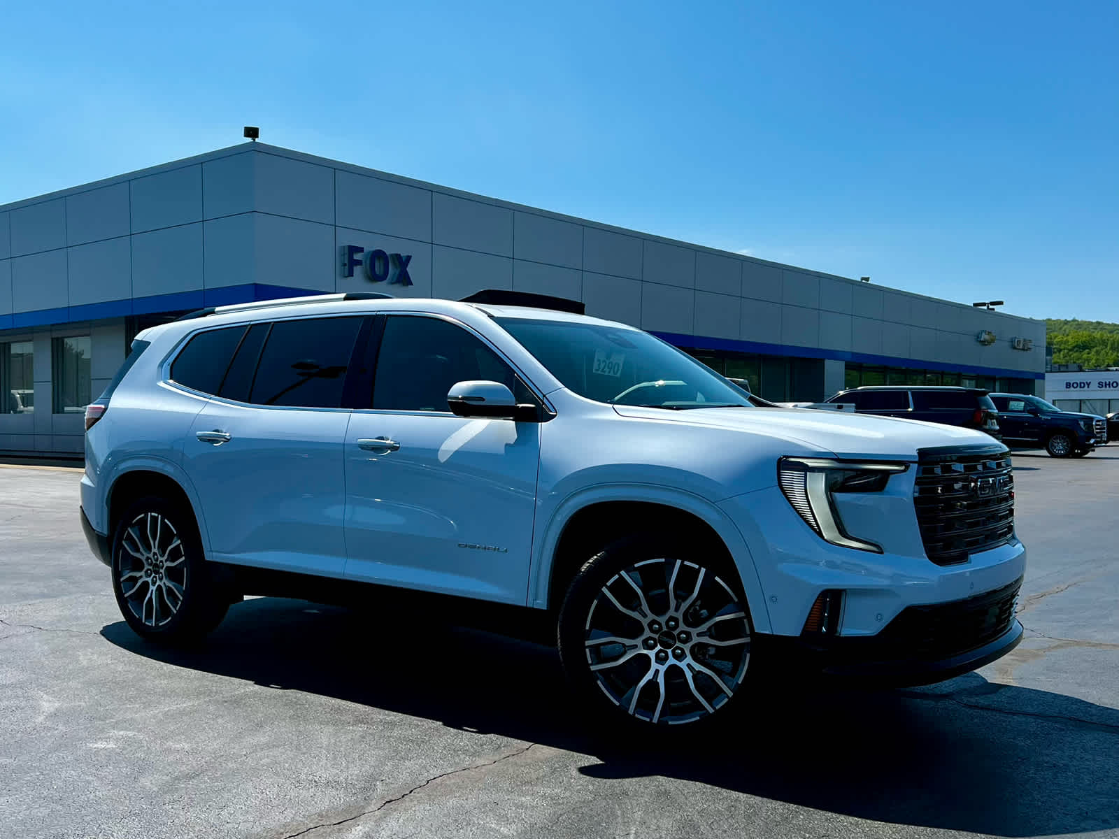 2026 GMC Acadia Denali Ultimate in Glacier White Tricoat — front three-quarter view