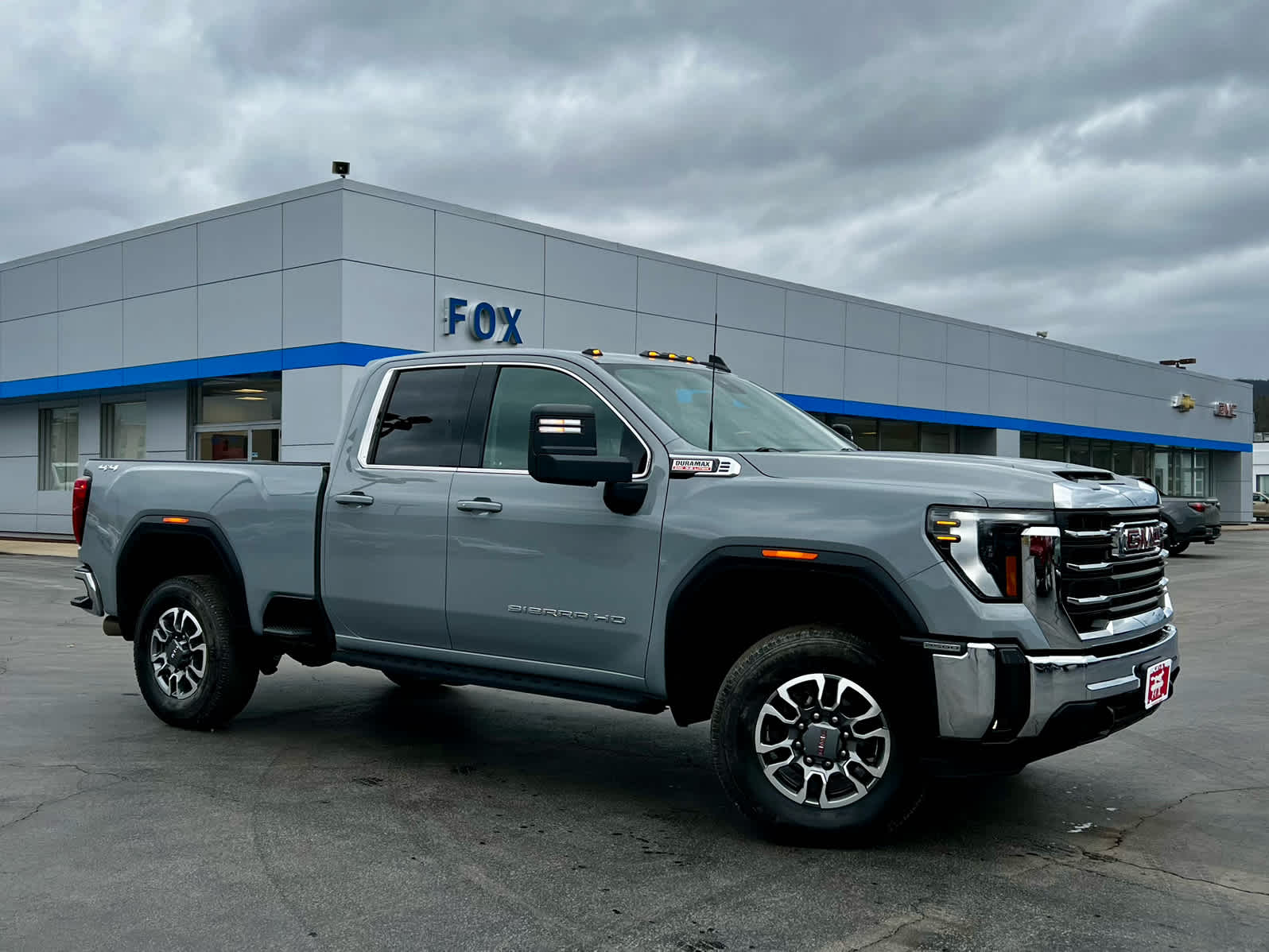 2025 GMC Sierra 2500 HD SLE in Thunderstorm Gray — front three-quarter view