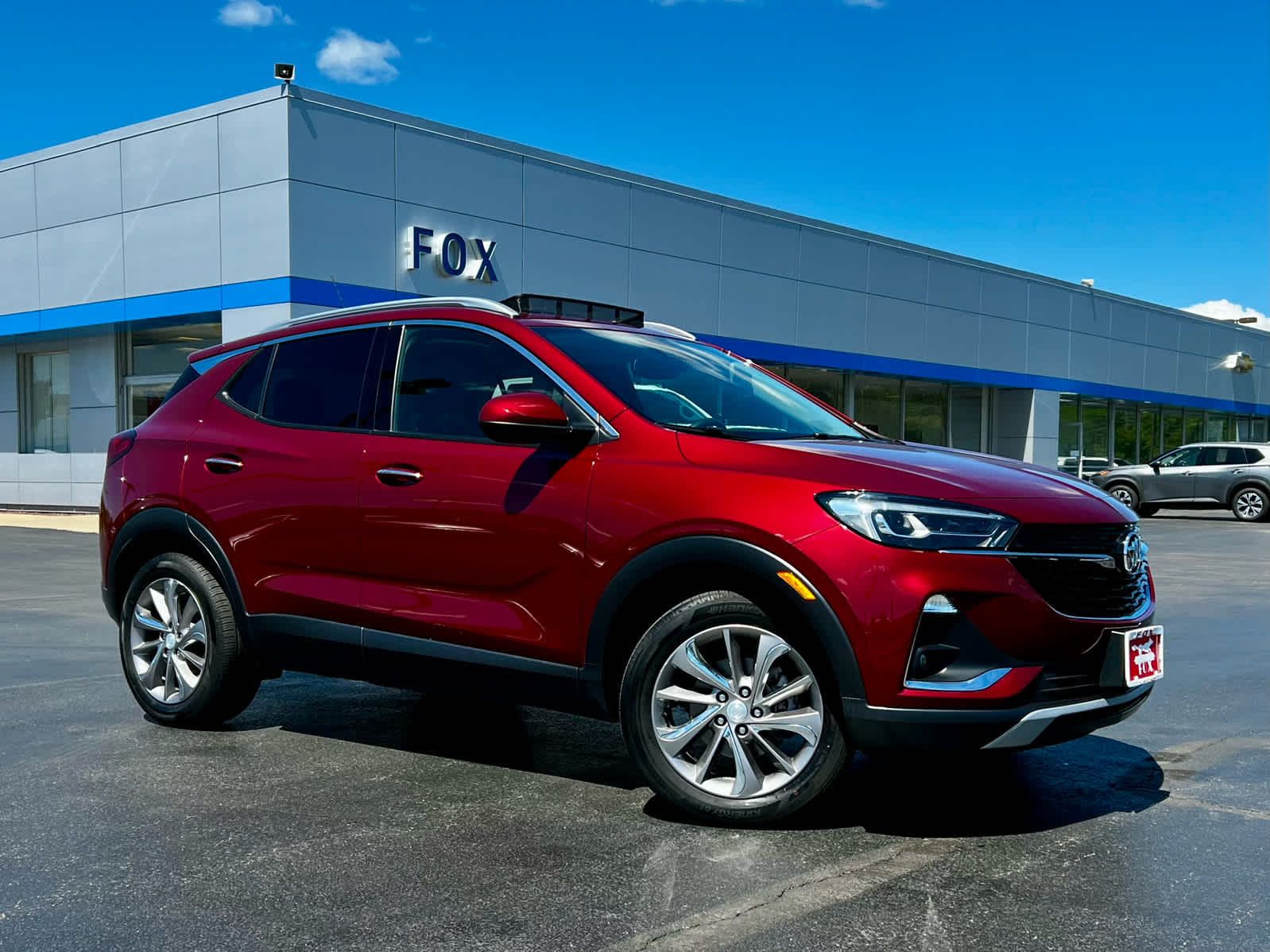 2023 Buick Encore GX Essence in Cinnabar Metallic — front three-quarter view